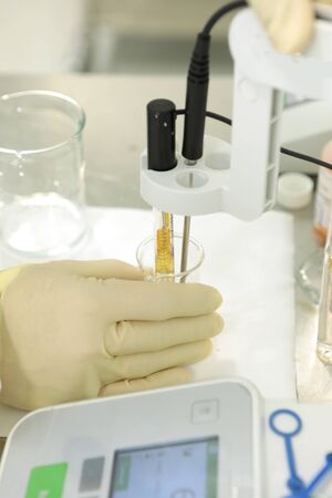 A chemist conducts a study of the stiffness of the solution. Laboratory PH measurement. A device for...