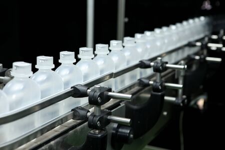 pharmaceutical industry, medicine pills are filling in the plastic bottle on production line machine...