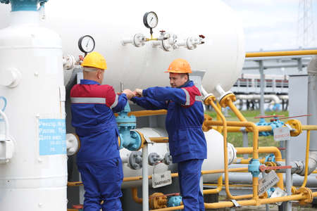 Oil and gas. A man repairs a gas turbine. Maintenance of a gas station by a person. Booster pumping...