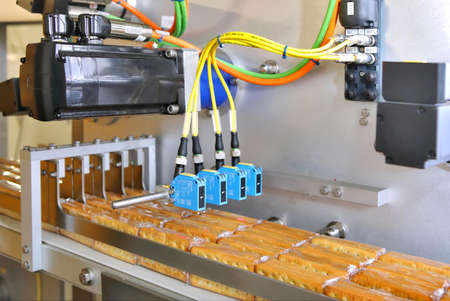 Large biscuit factory. A line of biscuits in a large factory. Packing crackers on the machine....