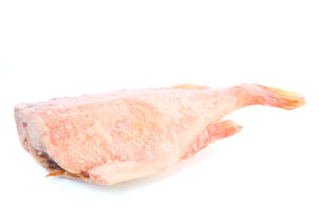 Frozen sea bass without a head. Frozen red fish Frost on the surface of the fish. Iceの写真素材