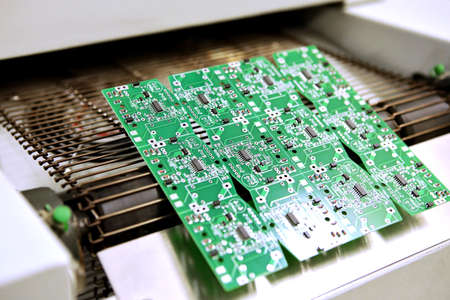 PCB drying technology. The finished board leaves the drying oven along the conveyor..