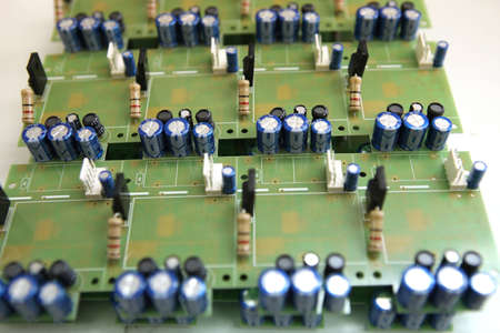 A man collects a printed circuit board. The worker solders the radio components and assembles the finished device. Manual assembly and controlの写真素材