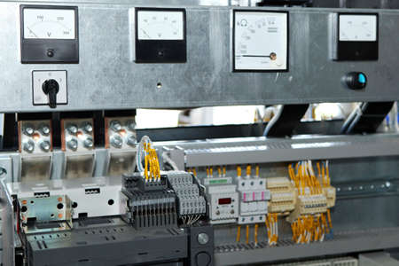 Electrician engineer work tester measuring voltage and current of power electric line in electical...