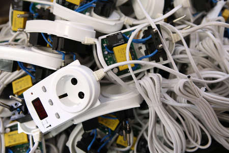 Service center for the repair of power voltage relays. Human checking electrical device with digital...