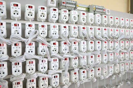 Quality control of electronic devices at the stand. Manufacture of sockets volt control and quality control. Lots of flashing electrical devicesの写真素材