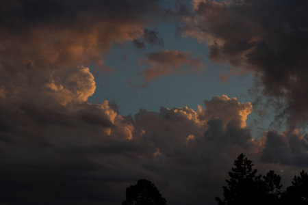 The sunset in the middle of the atlantic forest, with the sky with colors of orange, yellow, blue and red, of the city of ApiaÃ­, SÃ£o Paulo, Brazilの写真素材