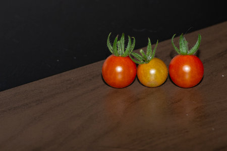 Small tomatoes (Solanum pimpinellifolium) on the table, under indirect light.の写真素材