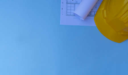 Top view of architect workplace. Architectural project, blueprints, blueprints on the blue desk....