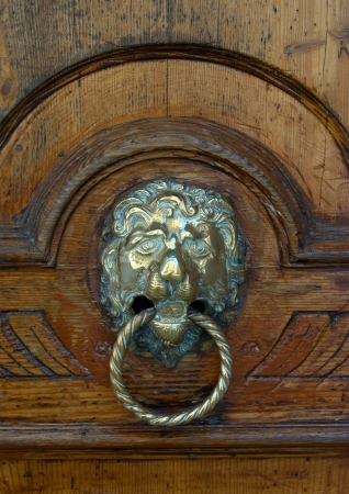 Old door knocker in the form of a lion s head with a ring の写真素材