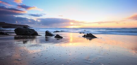 Amazing colours at the sunset in a beach, guincho beach cascais portugal. long exposure photoの写真素材