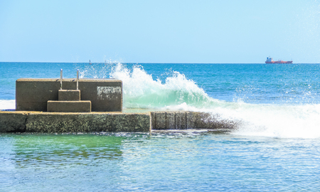 Wave crashing into the wall of an oceanic pool. Estoril, Portugalの写真素材