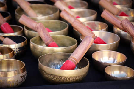 Tibetan singing bowls on black background, close-up