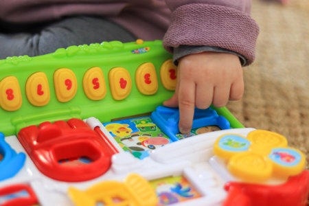 Baby's hands playing with educational toy