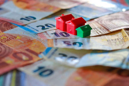 Euro banknotes and a small house. The concept of saving money.の写真素材