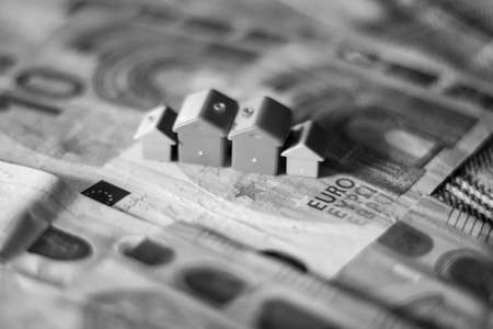 House model on the background of banknotes. Black and white photo.
