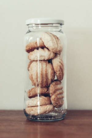 glass Jar with homemade cookies on light backgroundの写真素材