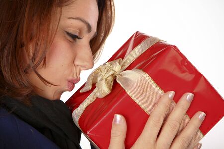 Happy Young Woman Kissing Her Christmas Presentの写真素材