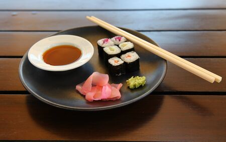Closeup Of Tasty Japanese Sea Food On A Plate With Fish And Chopsticksの写真素材
