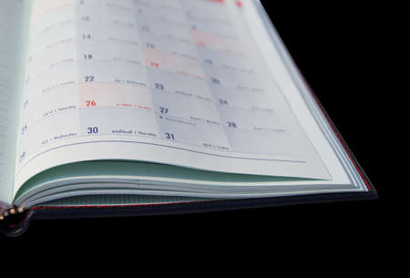 calender notebook on black backgroundの写真素材