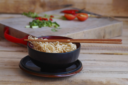 instant noodles with shiitake pepper and chilli n a bowl, Asian meal on a table