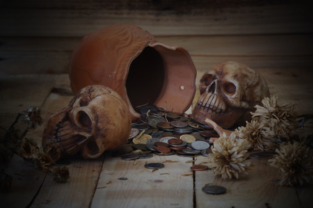 skull on bank note and coin, money, concept in work for money and death because of moneyの写真素材
