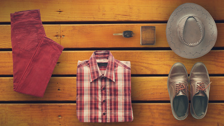 hipster clothes and accessories of man, on a wooden background in vintage style from top viewの写真素材