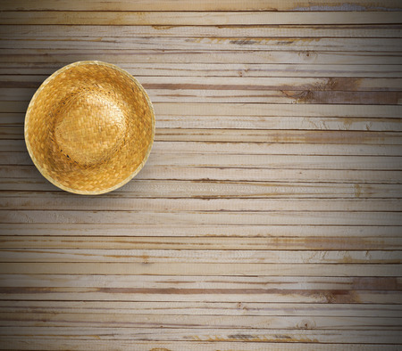 Weave in hat  from top view on wood backgroundの写真素材