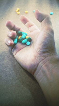 pill in hand and wanted drugの写真素材