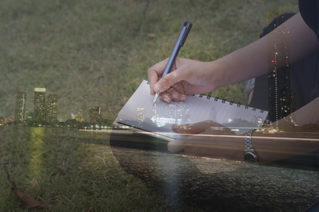 double exposure women writing at filed  and night cityの写真素材