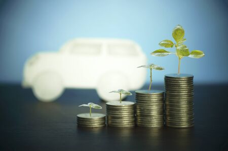 pile of money, coins with plant or tree growing up, concept in business about loan, selling,finance and buying carの写真素材