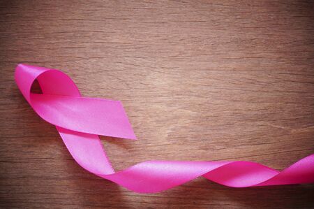 pink ribbon breast cancer on wood background with copy spaceの写真素材