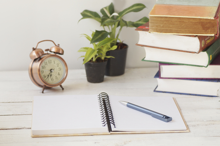 book and pen on table with plant, copy spaceの写真素材