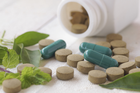 herb pill and leave for healthy, top view on wood table and copy spaceの写真素材