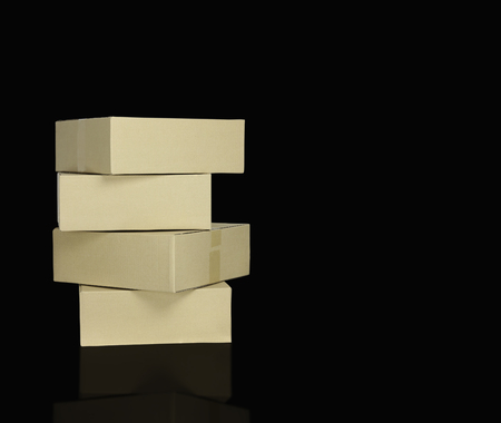 brown paper boxes stacked on blackbackground, can used to move in concept and delivery goods,...