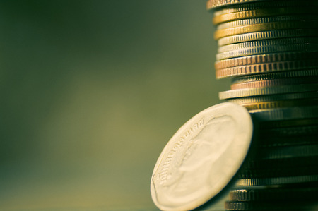 Stacked of coin money with copy space on green and retro background - concept as account, banking, grow and walk step by step for success in businessの写真素材