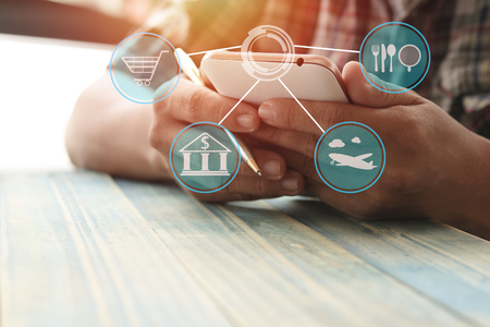 man use phone on wood table with copy space, concept as connect about finance, traveling, food and shoping onlineの写真素材