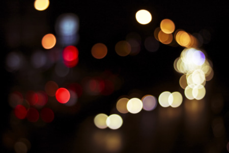 Defocused city night soft blur bokeh background of car light with a form of  love red shape, in retro and vintage styleの写真素材