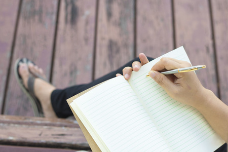 Writing dairy on notebook in park, concept as memory of life and education