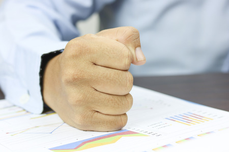 fist of businessman on work paper, concept as Confident and believe in success and financeの写真素材