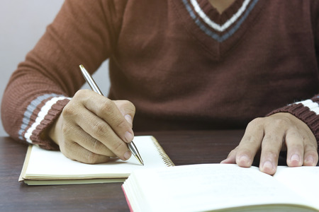 Writing dairy on notebook in coffee shop, concept as memory of life and education