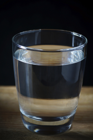 glass of drinking water on black background