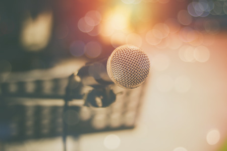 microphone and bokeh background, concept as music instrument in studio room and meeting hallの写真素材