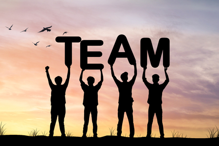 Silhouette of Businessmen holding team words in sunset , concept as teamwork and cooperate to success in businessの写真素材