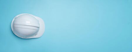 white construction and protection helmet on blue background 