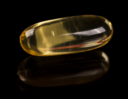 Cod liver oil omega 3 gel capsule on the dark glassの写真素材