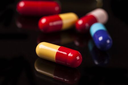 Medical pills on the black glassの写真素材