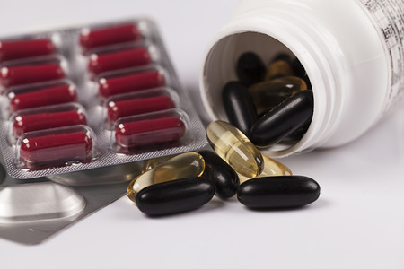 Pills spilling out of prescription bottle and blisterの写真素材