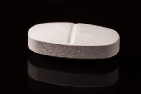 white pill on black relational backgroundの写真素材