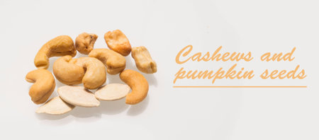 cashews and pumpkin seeds against white backgroundの写真素材